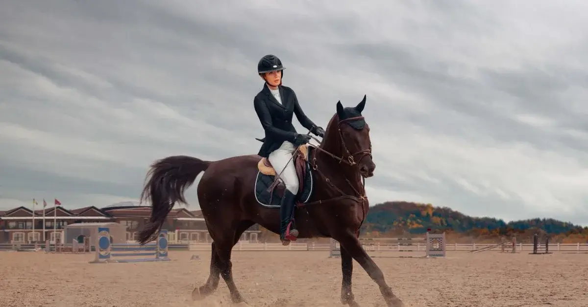 a beautiful lady is riding a race horse