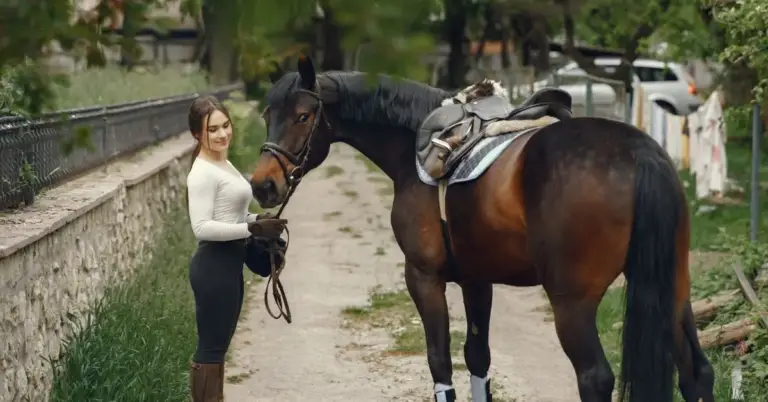 a beautiful girl is standing near a popular horse names